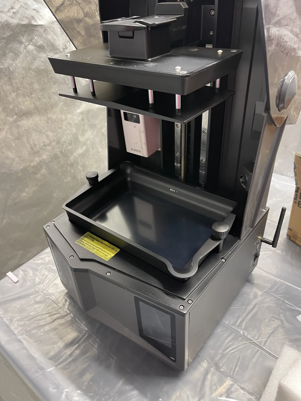 The Saturn 4 Ultra with the resin vat and build plate from the preceding two box photos in place; the vat is empty, and the antenna is attached.