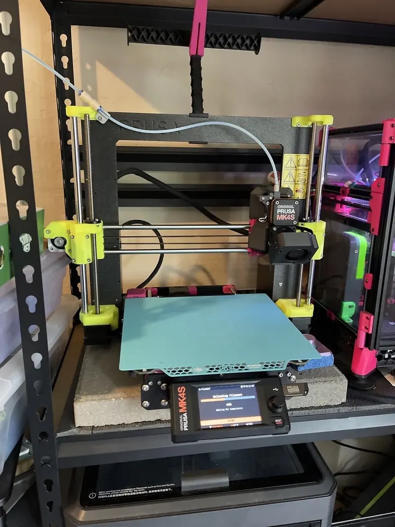 Pam, an Original Prusa MK4S with lime green printed parts and a turquoise build plate.